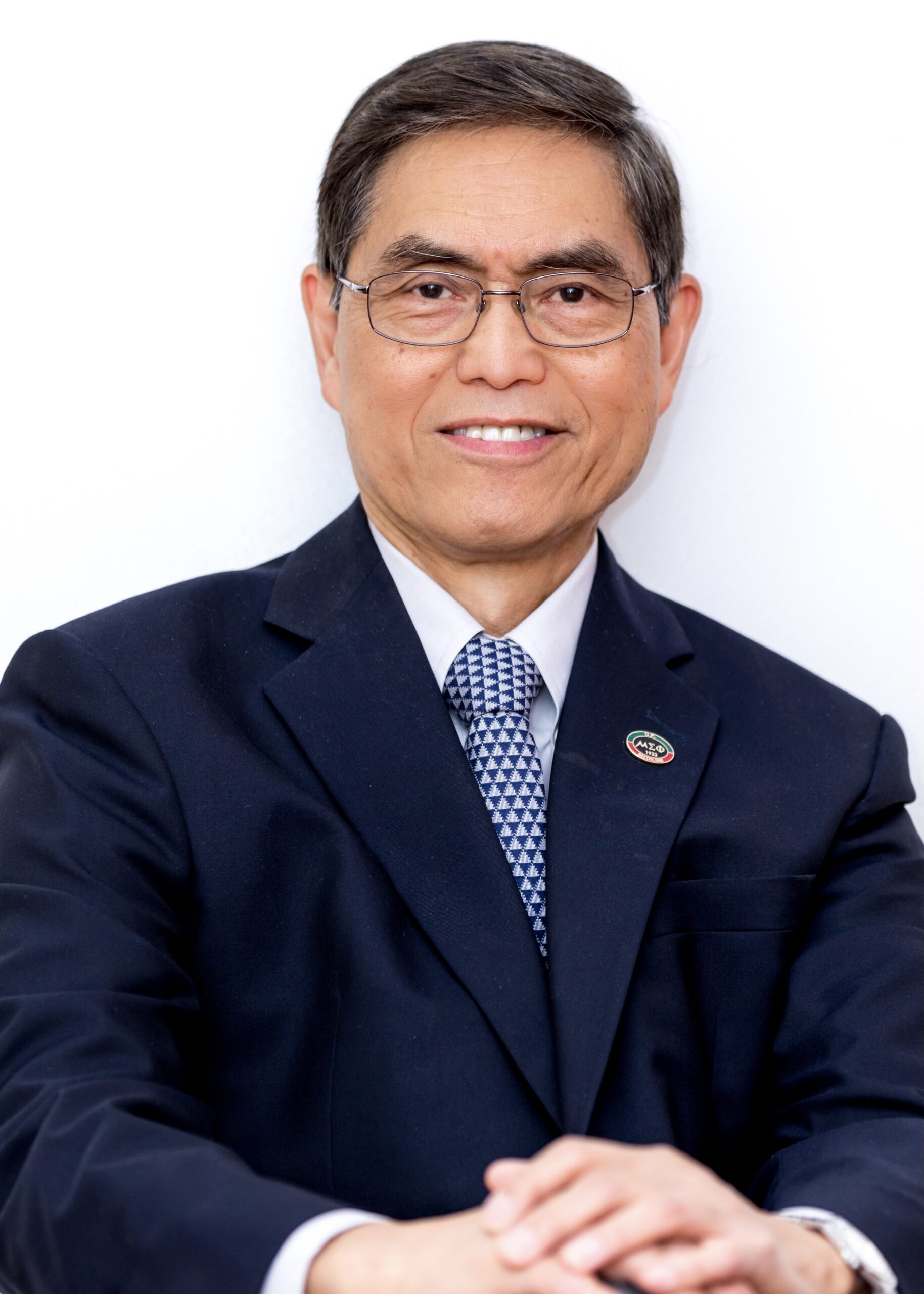 Dr. Guinto smiling in a dark blue suit